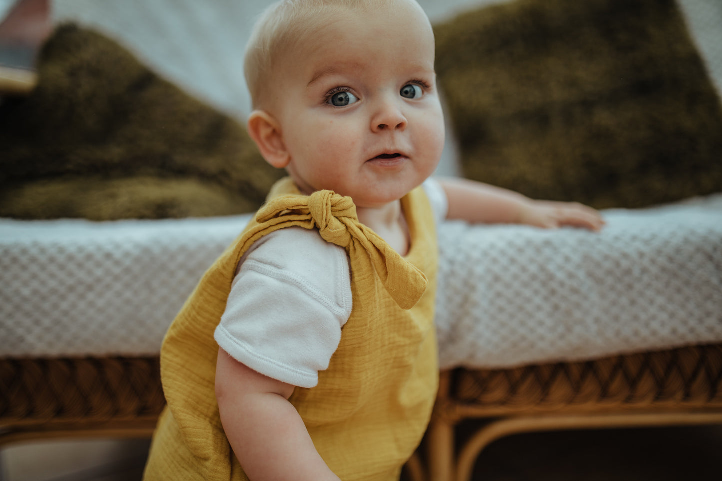 baby boy close up of harem romper adjustable straps double gauze in mustard blue eye toddler girl unisex sustainable hippy style clothing