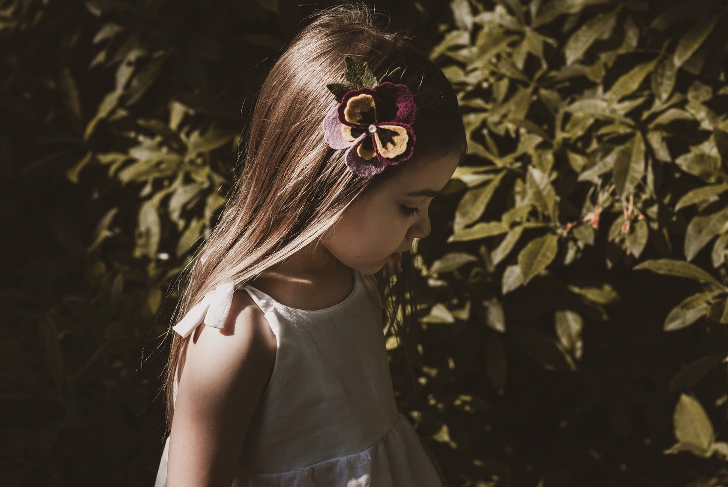 girl stood in garden in summer wearing a cotton linen dress in white adjustable straps sustainable bohemian hippy beach clothing